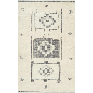 A rectangular rug with a geometric Moroccan printed design in a muted color palette.